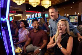 Live AduQ table interface showing card deal and sportsbook panel